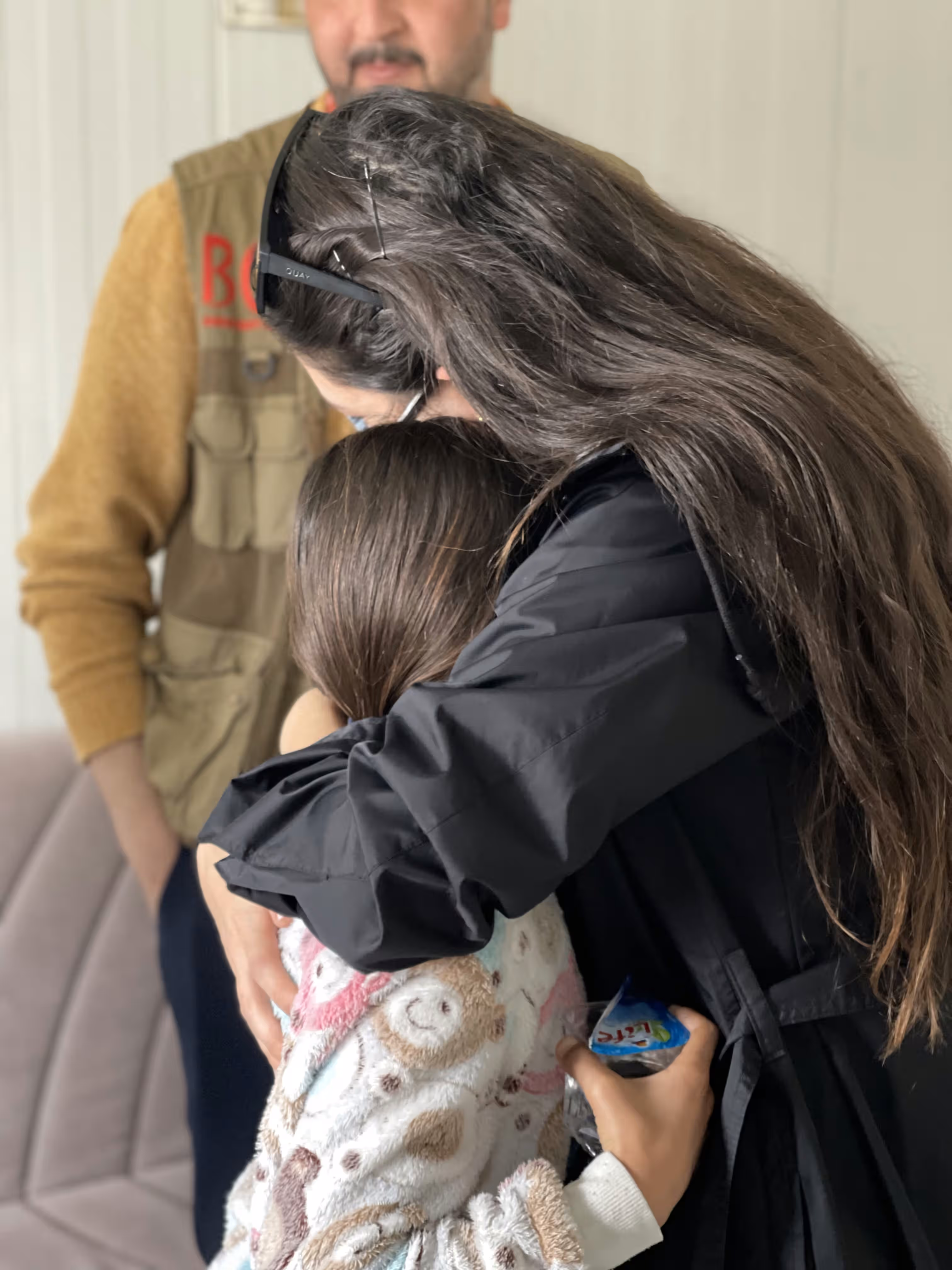 Photograph illustrating EMERGE's "Caregiver and family strengthening" response for children at risk